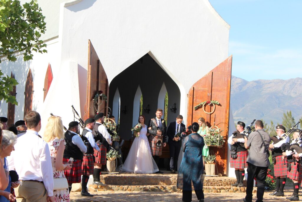 Nelson Mandela playing bagpipes and drums at a wedding at a wine farm